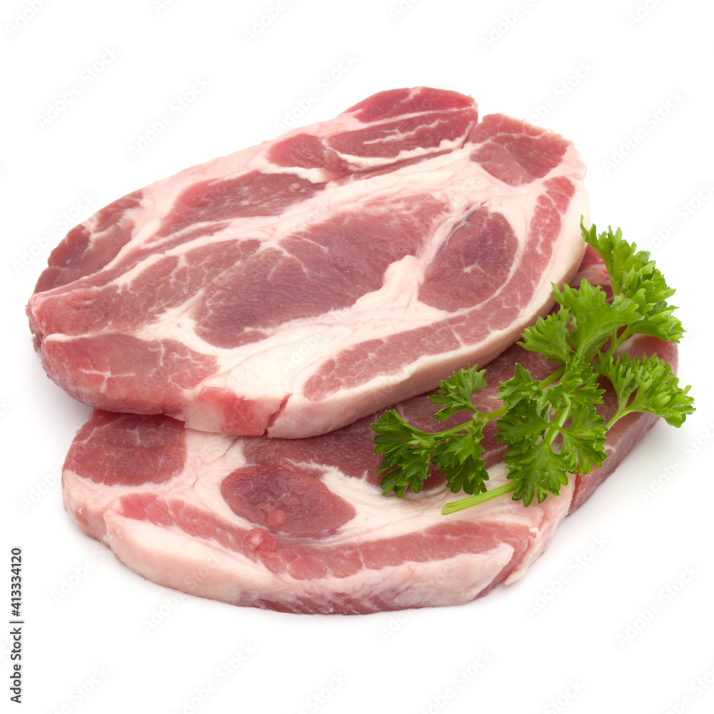 Raw pork neck chop meat with parsley herb leaves garnish isolated on white background cutout Raw pork neck chop meat with parsley herb leaves garnish isolated on white background cutout