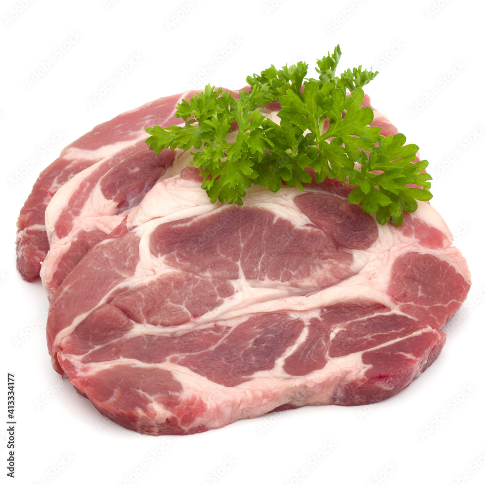Raw pork neck chop meat with parsley herb leaves garnish isolated on white background cutout Raw pork neck chop meat with parsley herb leaves garnish isolated on white background cutout