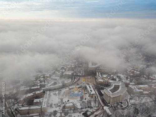 Fog over the snow-covered St. Michael's Cathedral in Kiev. Aerial drone view. Foggy winter day.