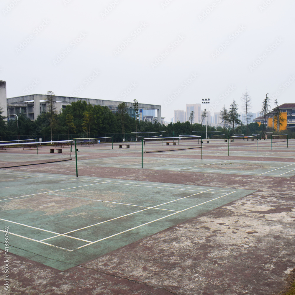 Obraz premium Chongqing, China - December 24 2019: An eerie, run down scene of dozens of badminton courts at the Chongqing University under a continuous grey sky
