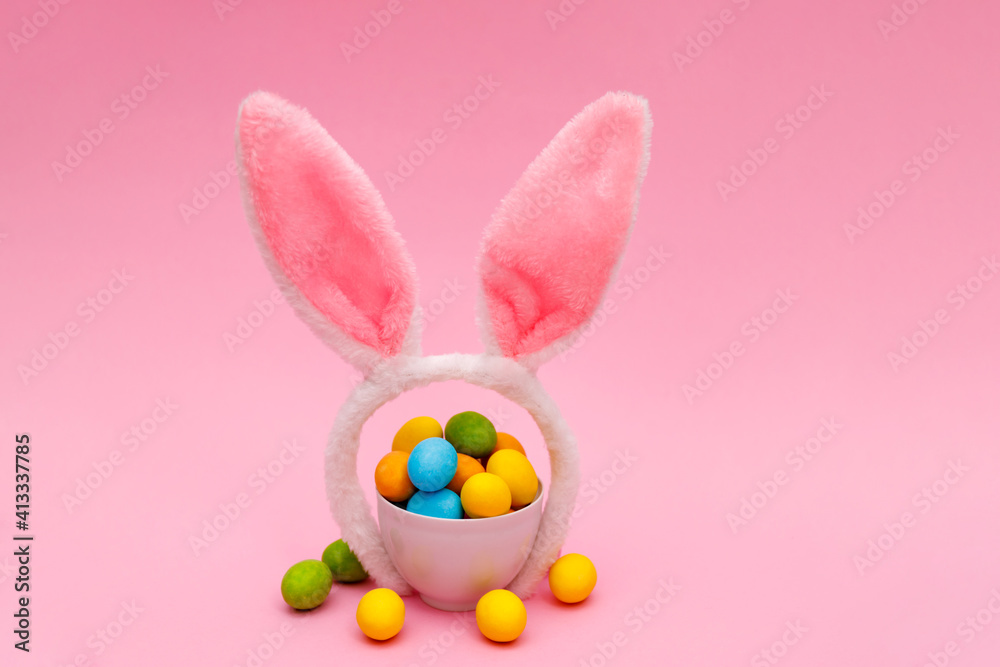 Fototapeta premium Easter bunny. Happy Easter holiday background concept.Flat lay colorful bunny egg with accessory to celebration on modern rustic pink pastel paper at home office desk.