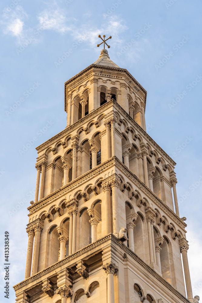 Bell tower of St. Domnius Church in golden sun light in early morning in Diocletian Palace in Split Croatia