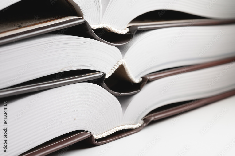 Binding of a new book. Close-up of a layer of pages. Library background Binding of a new book. Close-up of a layer of pages. Library background