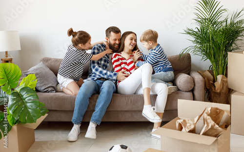 Happy family playing on sofa during relocation