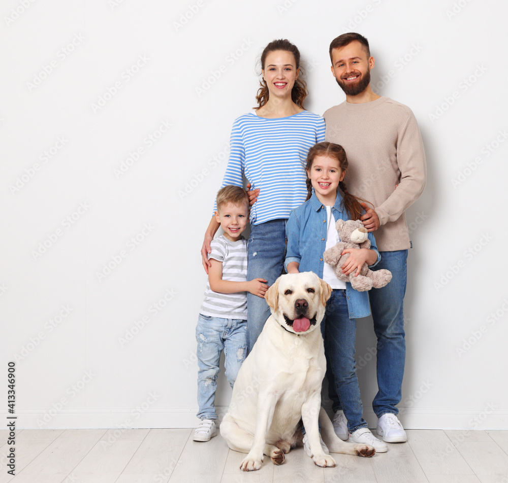 happy family playing with their favorite pet dog   on blank wall