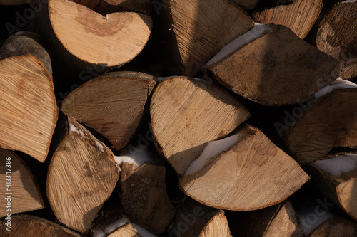 Woodpiles are freshly cut logs. A stack of tree trunks. Timber processing in the warehouse of wooden building structures. Kick the chopped wood. Forestry. photo