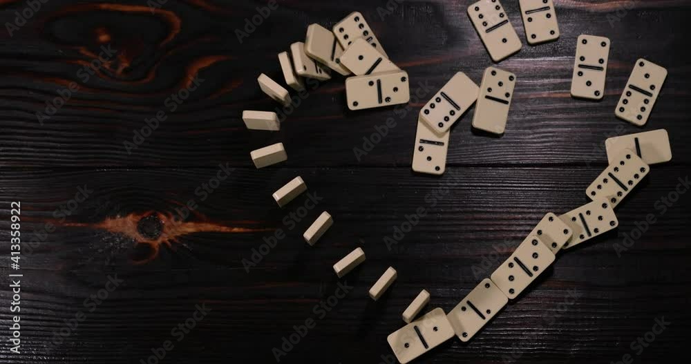 Falling domino effect. Domino pieces in the form of a heart. Slow motion