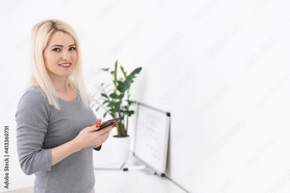 Portrait of beautiful young woman using her mobile phone at home. Portrait of beautiful young woman using her mobile phone at home.