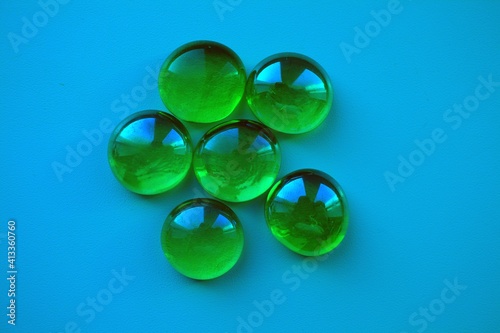 green glass stones on a blue background