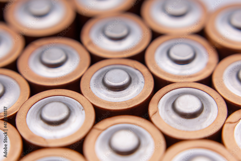 Close up of positive ends of AA batteries. Selective focus Close up of positive ends of AA batteries. Selective focus