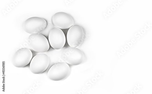 Chicken white eggs on a white plate, nine pieces. Horizontal photo, flat lay. Concept - ingredients for a dish, food photography, white on white