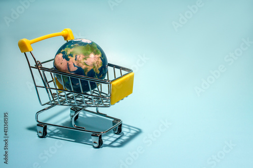 Fototapeta Naklejka Na Ścianę i Meble -  planet earth in supermarket trolley, online shopping. Concepth photo of Earth Day