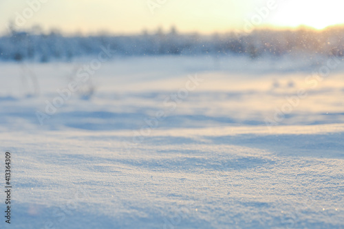 snow close-up on background of winter landscape with soft focus 