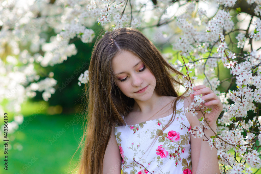 Pretty little girl in blooming apple tree garden on beautiful spring day Pretty little girl in blooming apple tree garden on beautiful spring day