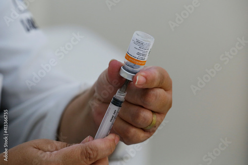 A nurse prepares a dose of the CoronaVac vaccine for COVID-19 during a priority vaccination program for people with more than 90 years old in Sao Paulo, Brazil. photo