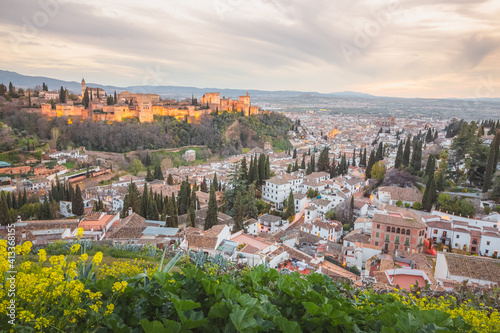 Sunset or sunrise cityscape view of the Alhambra and the historic Moorish or Arab Quarter (albaicin) in Granada, Andalusia, Spain.