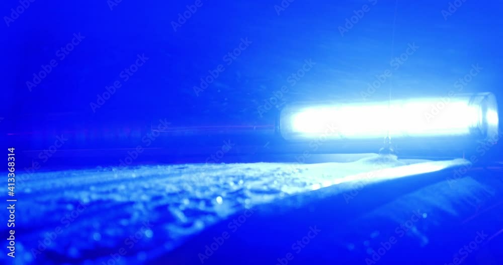 Flashing lights of a police car at night, it is snowing Flashing lights of a police car at night, it is snowing