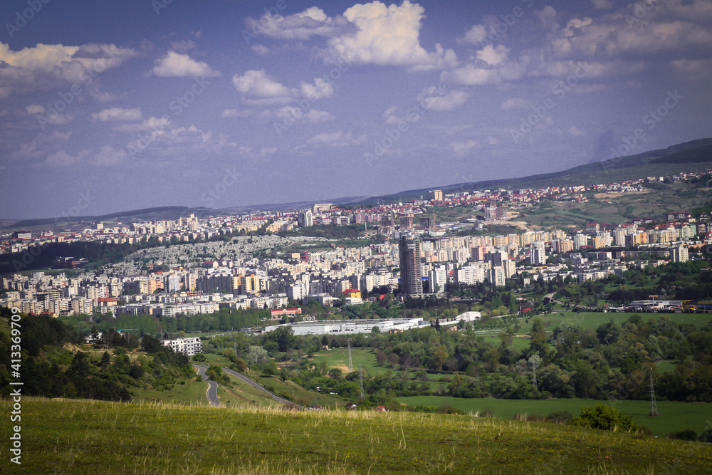 Landscape of a city from the hill view during summer time and the meadow, very beautiful view of a big city.