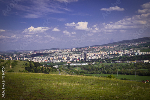 Landscape of meadow and the city in the back, beautiful view from the hill.