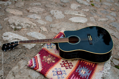 Guitar laying on oriental rug on the Roman Bridge in Sarajevo photo