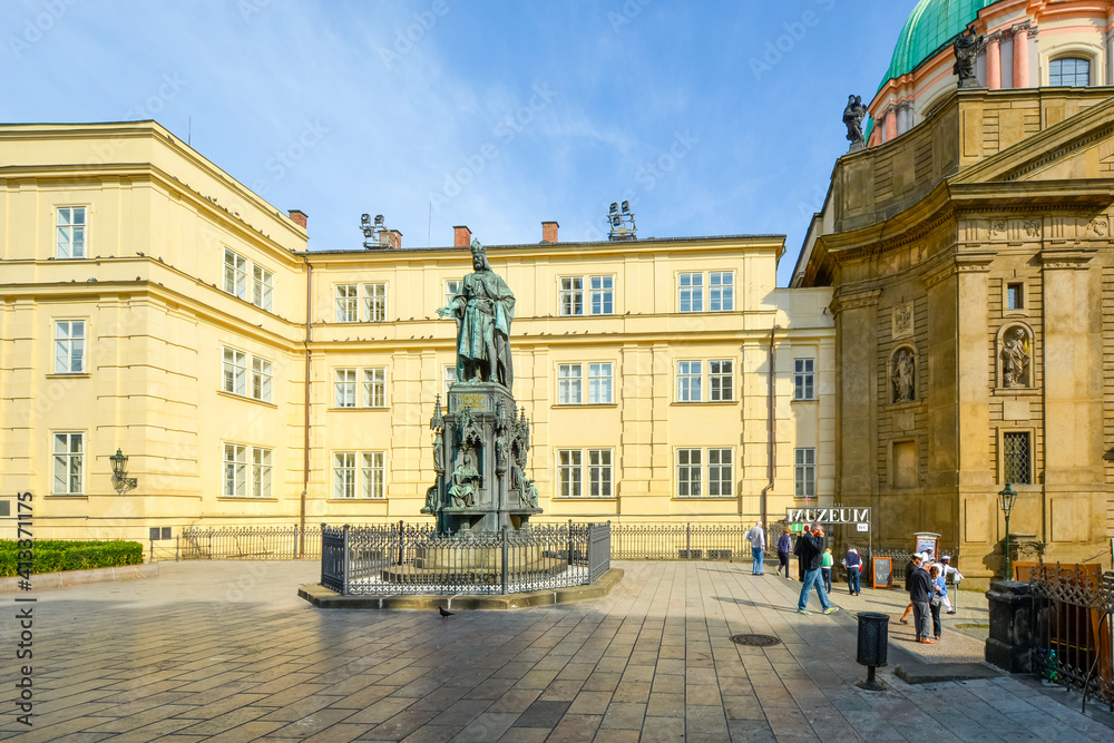 Tourists enter the Charles Bridge Museum near the statue of Charles IV in the Knights of the Cross Square near the Old Tower in Prague, Czechia