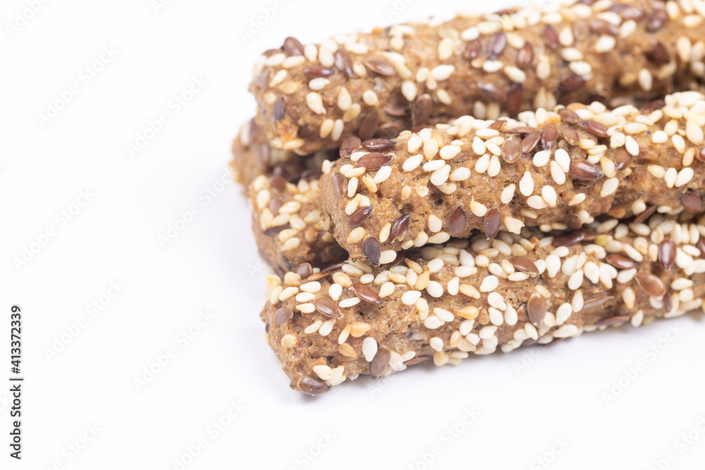 Tasty Sesame sticks closeup above white background. Tasty Sesame sticks closeup above white background.