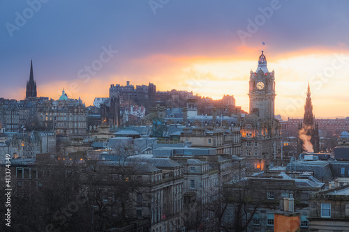 Classic sunset or sunrise cityscape view from Calton Hill taking in Princes Street  Edinburgh Castle and the Balmoral Clock Tower at Waverley Station in Edinburgh  Scotland.