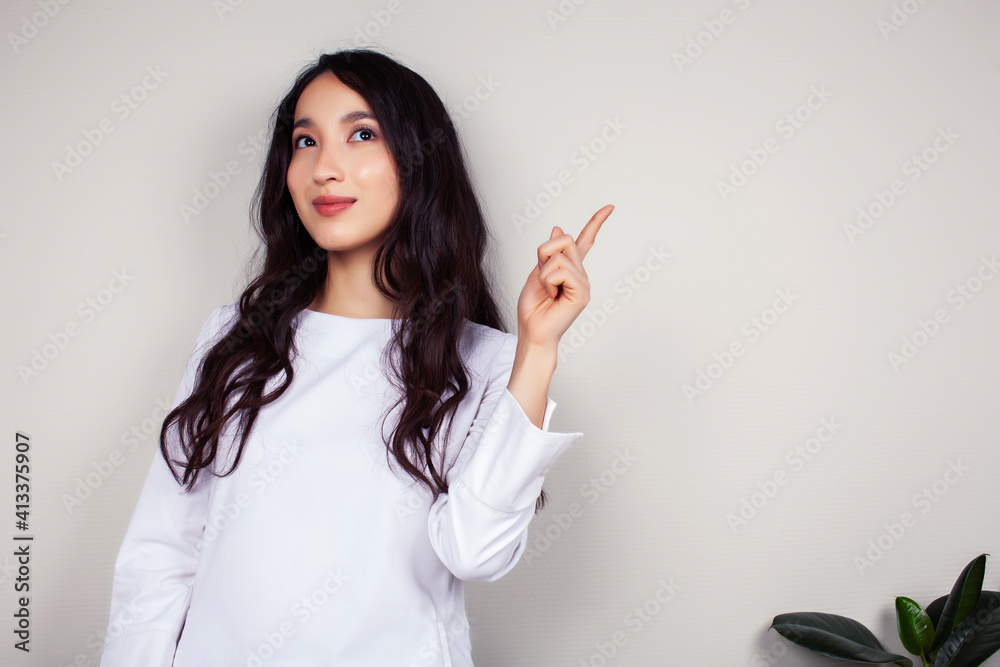 young asian woman doctor in white uniform gesturing positive on gray background, lifestyle healthcare people concept young asian woman doctor in white uniform gesturing positive on gray background, lifestyle healthcare people concept
