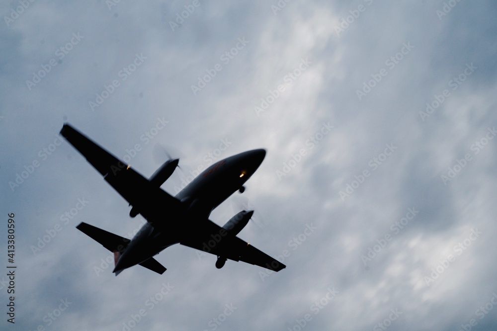 Plane arriving at the airport in cloudy afternoon Plane arriving at the airport in cloudy afternoon