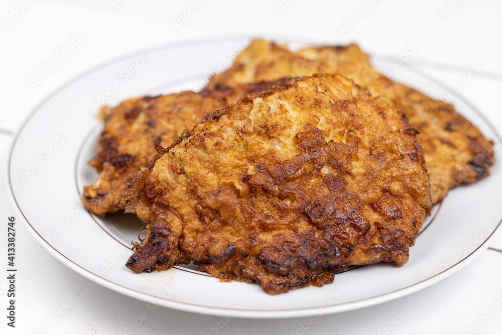 Pork meat Fried in eggs and flour served on the plate Pork meat Fried in eggs and flour served on the plate