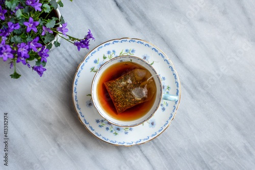 Canvas Print Top view of a cup of hot tea in a pretty vintage teacup