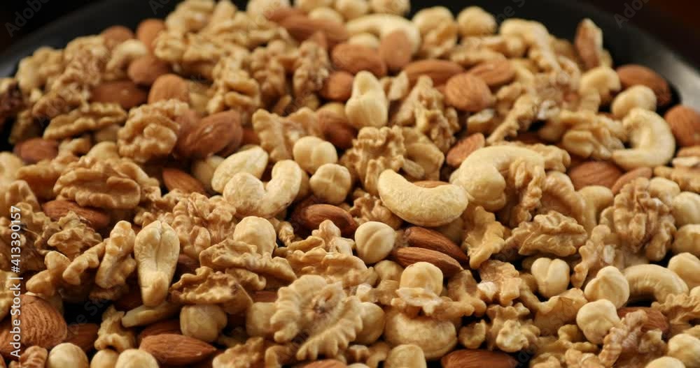 Assorted healthy organic nuts rotating Assorted healthy organic nuts rotating
