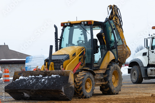 tractor lifting asphalt