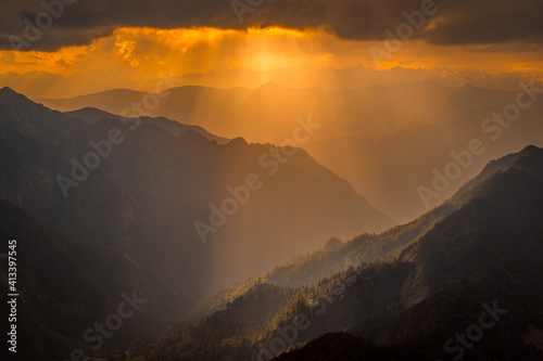 Sunset over the mountains. Serene golden hues of sun rays at Himalayan snowscapes mountains, Parvati valley, Kasol, Himachal Pradesh, northern India. © shekhar