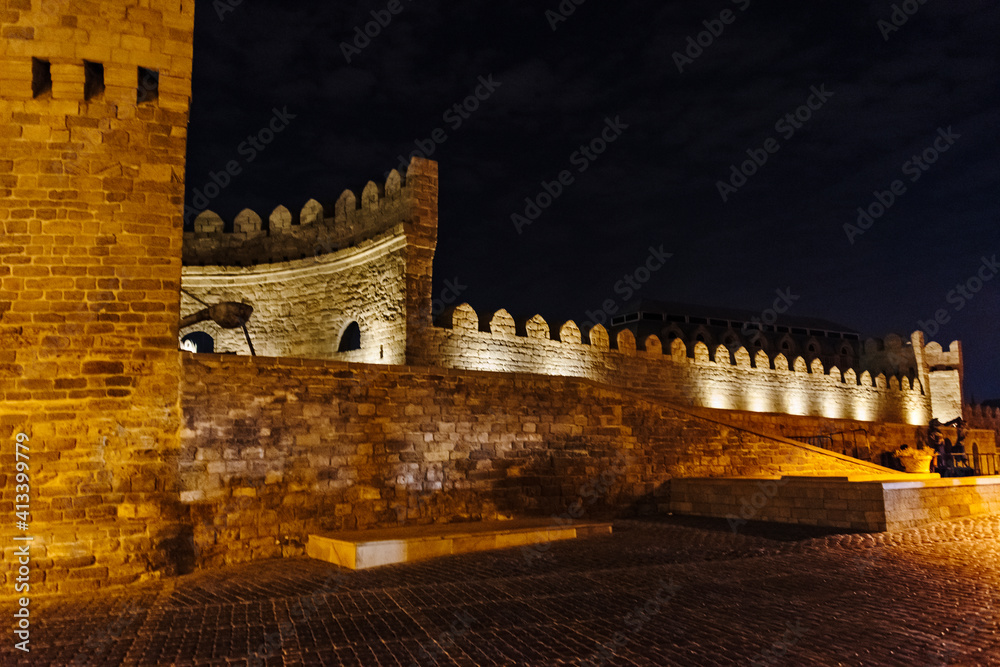 Old city wall and cobbled street in the Inner City of Baku at night, Azerbaijan