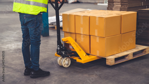 Factory workers deliver boxes package on a pushing trolley in the warehouse . Industry supply chain management concept . photo