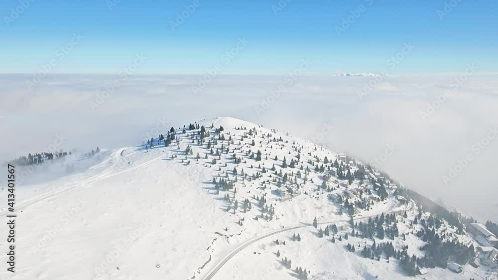 Beautiful winter landscape mountain summit dense layer fog hilly scenery snow evergreen trees nature skyline blue sky horizon ski resort aerial motion Beautiful winter landscape mountain summit dense layer fog hilly scenery snow evergreen trees nature skyline blue sky horizon ski resort aerial motion