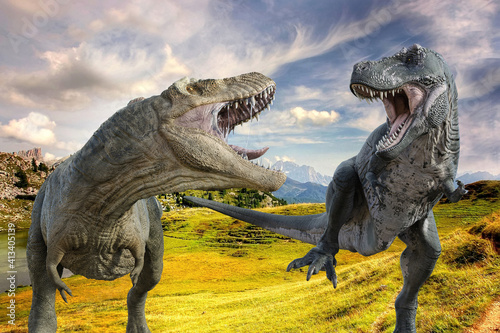 大草原の中を白っぽいティラノサウルスと青っぽいティラノサウルスが走りながら牙を見せ合い威嚇している © iARTS_stock