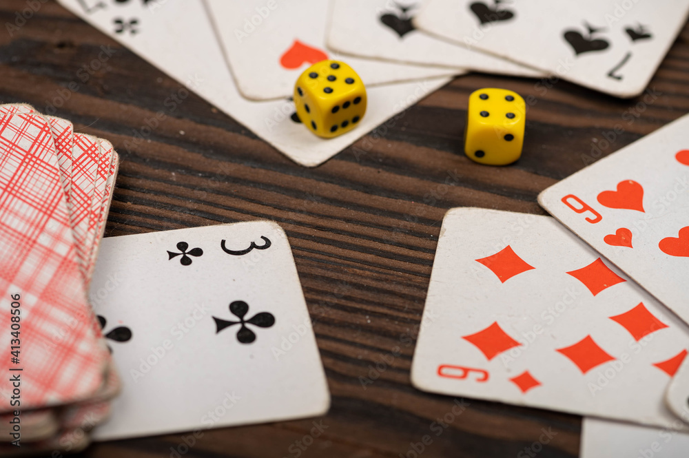 Playing cards and dice on a wooden table. Playing cards and dice on a wooden table.
