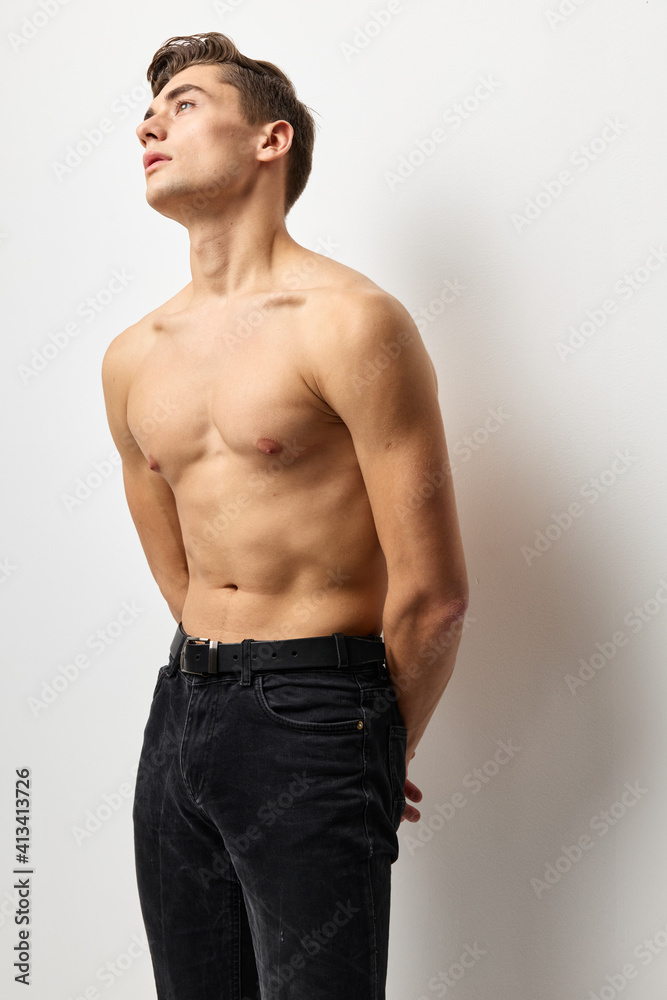 Young man with a naked torso looking up posing self-confidence Young man with a naked torso looking up posing self-confidence