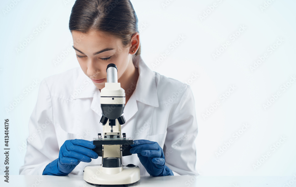 woman with microscope at the table in laboratory research microorganism bacteria woman with microscope at the table in laboratory research microorganism bacteria