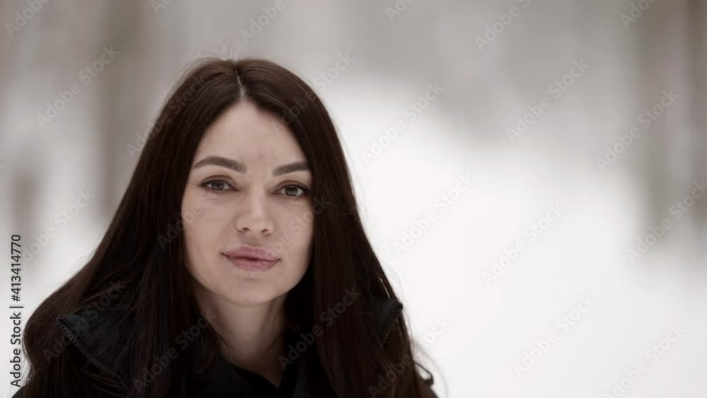 calm brunette woman is walking in winter at nature, closeup portrait calm brunette woman is walking in winter at nature, closeup portrait