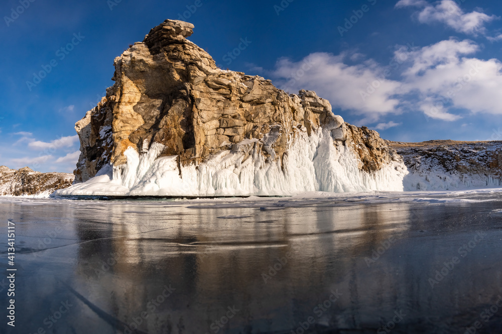 Ice-covered rock on Oltrek Island. Winter Baikal