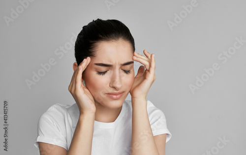woman in white t-shirt cropped view health problem headache