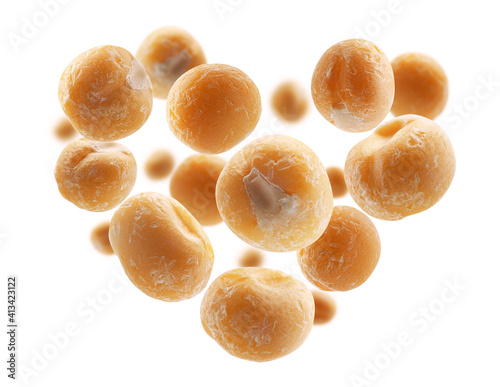 Dry yellow peas in the shape of a heart on a white background