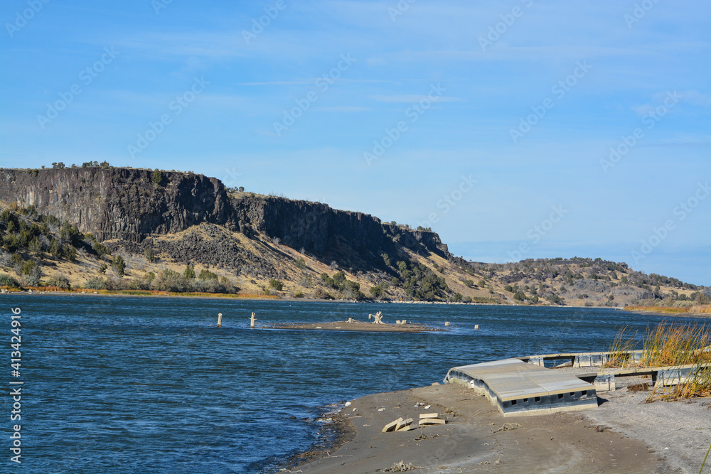 Low water level exposing the rocky shore and beaching a dock on the Snake River In Northern Idaho