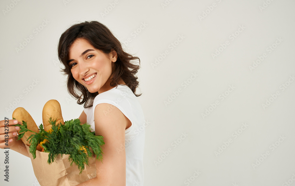 Brunette in a white T-shirt eating healthy food Brunette in a white T-shirt eating healthy food