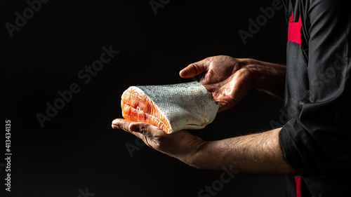 Photography Cook hands prepares steak fish salmon, The big piece salmon is in the hands of the chef cook