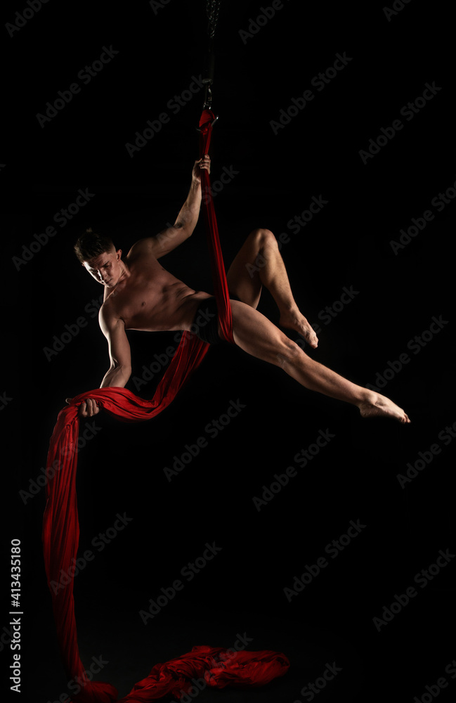 aesthetics of the body, gymnast with red cloth, gymnast on a black background