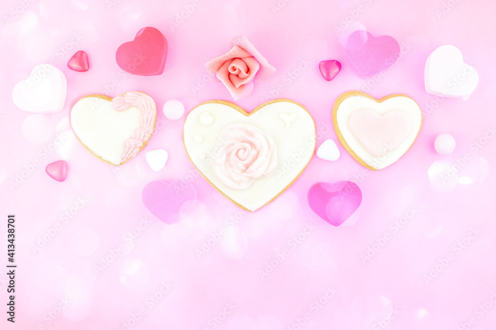 Decorated heart shaped and rose cookies on pink background, flat lay with space for text. Marshmallow, Biscuit and Candy sweets. Valentine's day concept. Blurred bokeh light bubble background